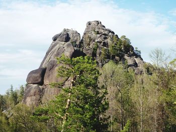 Low angle view of rock formation against sky