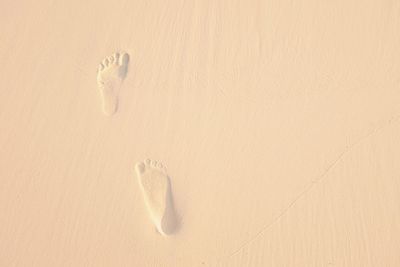 High angle view of footprints on sand