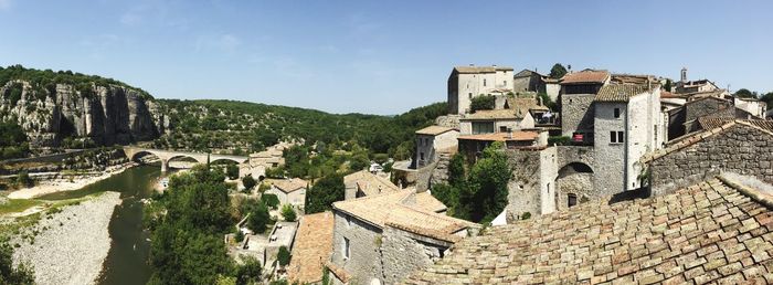 Panoramic view of buildings against sky during sunny day