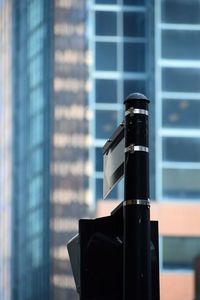 Close-up of camera on glass window of building