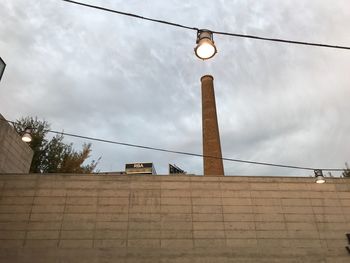 Low angle view of illuminated street light against sky