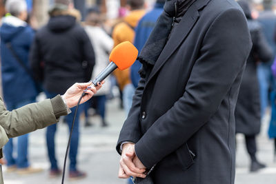 Reporter holding microphone making media interview. street interview or vox popoli.
