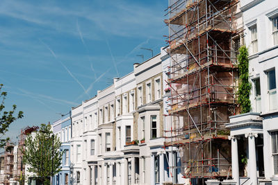 Traditional townhouses in notting hill, one of which is being renovated, london