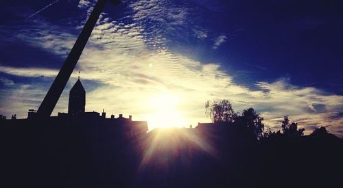 Low angle view of silhouette trees against sky at sunset