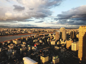 High angle view of cityscape against cloudy sky