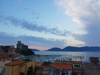 High angle view of townscape by sea against sky