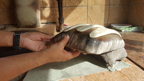 Low section of man working on wood