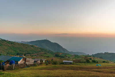 Scenic view of field against sky during sunset