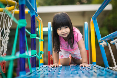 Smiling girl playing at playground