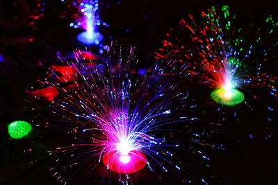 Low angle view of firework display at night