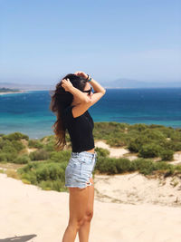 Full length of woman standing on beach