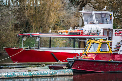 Side view of boats moored in river