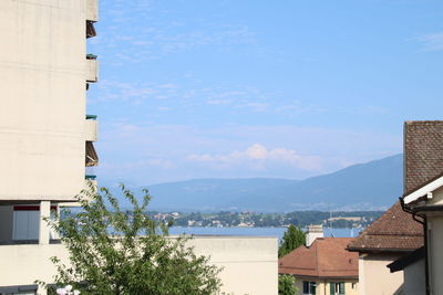 Buildings in town against sky