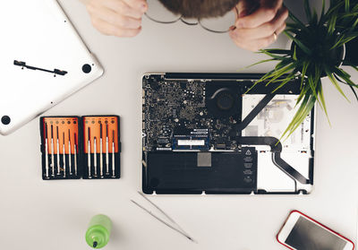 Directly above shot of circuit board with equipment on table