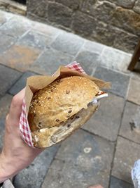High angle view of person holding ice cream on footpath