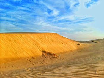 Mountain on sand dunes in desert