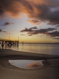 Scenic view of beach against sky during sunset