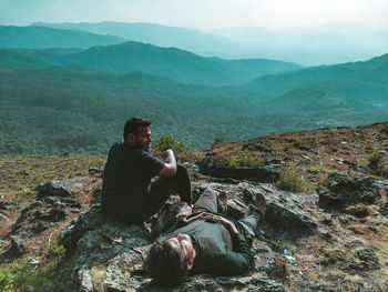 Friends relaxing on mountain
