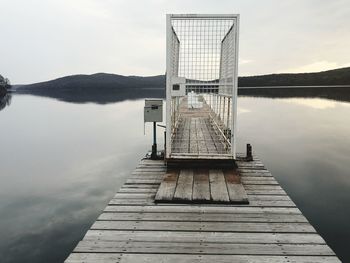 Pier over lake against sky