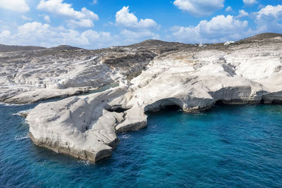 Scenic view of sea and mountains against sky