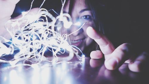 Close-up of woman with lighting equipment