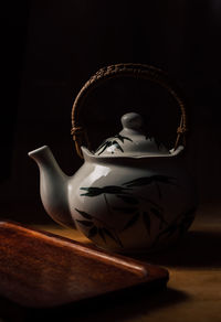 Close-up of mannequin on table against black background