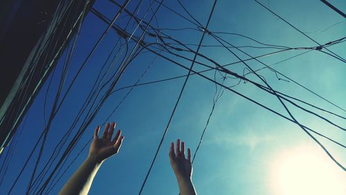 Low angle view of woman against blue sky