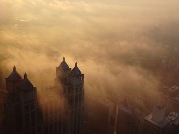 Buildings against cloudy sky