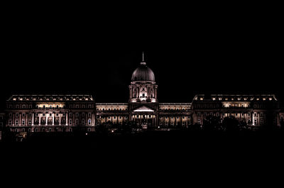 Illuminated building against sky at night