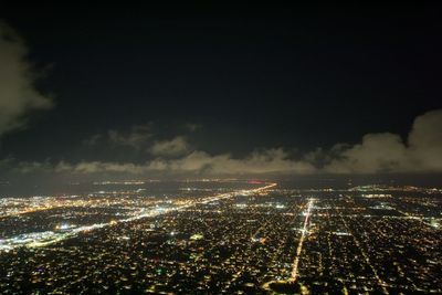 High angle view of city lit up at night