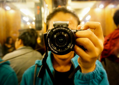 Close-up of woman photographing with digital camera