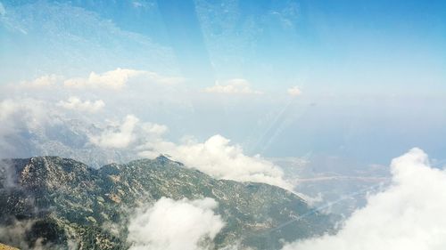 Scenic view of mountains against cloudy sky