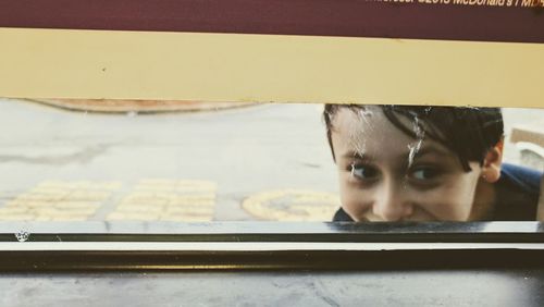 Young woman peeking through window