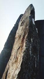 Low angle view of rock formation against clear sky