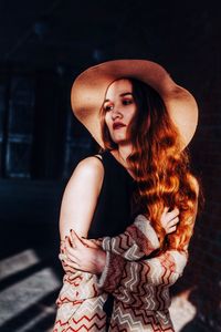 Portrait of young woman wearing hat