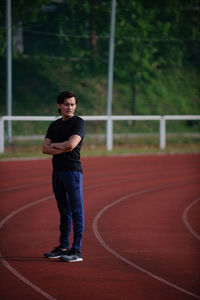 Portrait of young man standing on track