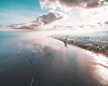 Aerial view of sea against cloudy sky