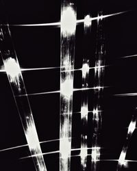 Low angle view of illuminated lights at night