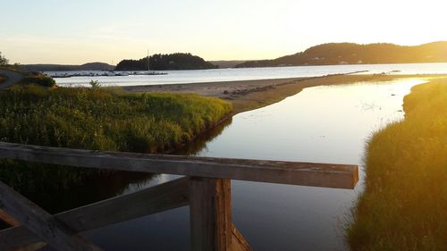 Scenic view of lake against sky during sunset