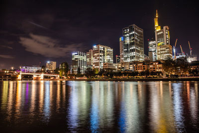 Illuminated city at waterfront