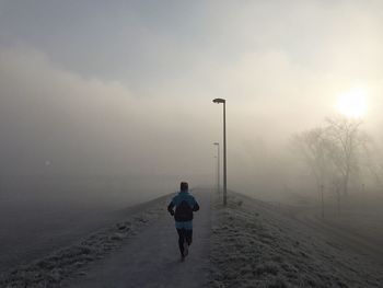 Rear view of athlete running in the morning