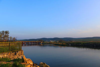 Scenic view of lake against clear blue sky