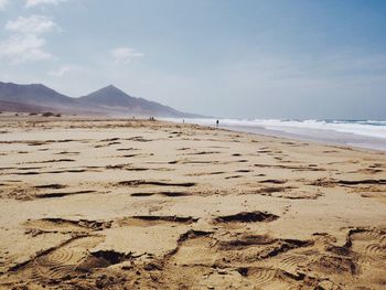 Scenic view of beach against blue sky