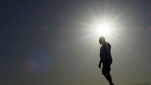 Silhouette man standing against sky during sunset