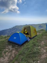 Scenic view of tent on field against sky