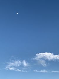 Low angle view of moon in blue sky