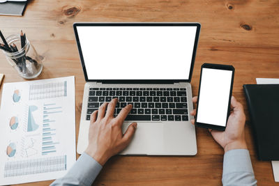 Low section of person using laptop on table