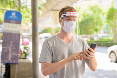 Portrait of young man using mobile phone