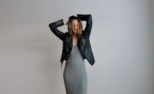 Woman standing against black background