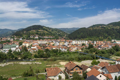 Townscape by mountains against sky